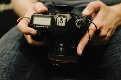 Close-up of hands holding digital camera