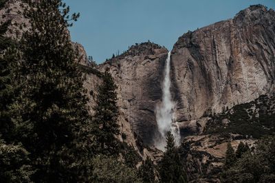 Scenic view of waterfall against sky