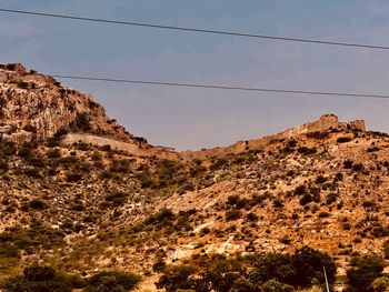 Low angle view of rocky mountains against sky