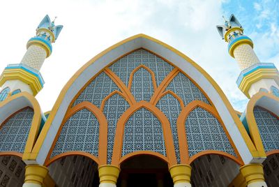 Low angle view of yellow building against sky