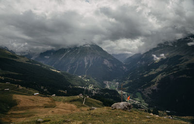 Scenic view of valley and mountains against sky