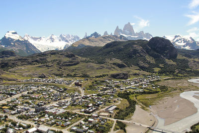 High angle view of townscape and mountains against sky at el chaltén, patagonia argentina