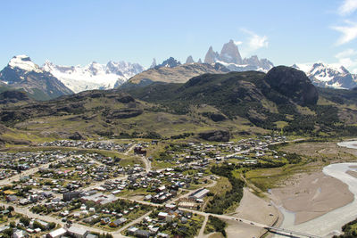 High angle view of townscape and mountains against sky