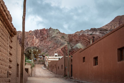 Buildings in town against sky