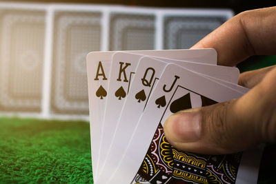 Cropped hand of person holding cards