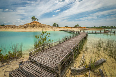 View of empty footbridge over lake 