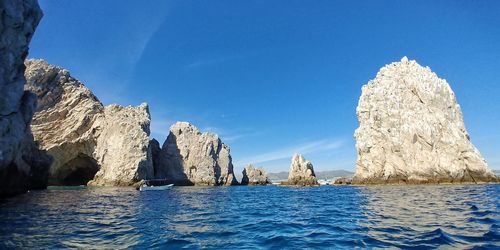 Panoramic view of sea against clear blue sky