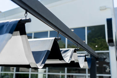 Low angle view of clothes hanging on railing against building