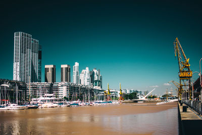 Modern buildings in city against clear sky