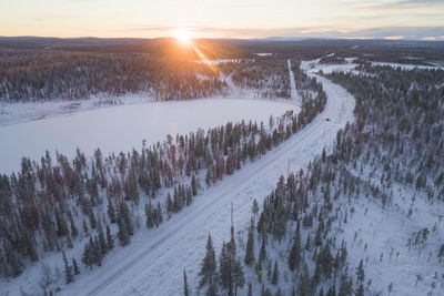 Panoramic shot of snow covered land during sunset