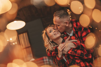 Candid authentic happy married couple spends time alone at lodge xmas decorated