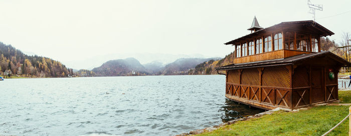 Scenic view of lake and buildings against clear sky