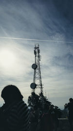 Rear view of silhouette man using mobile phone against sky