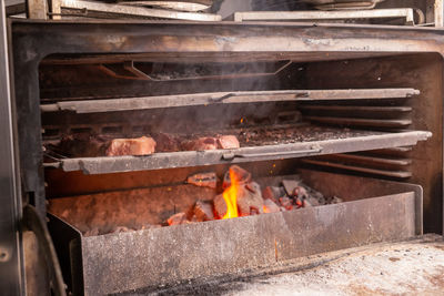 High angle view of meat on barbecue grill