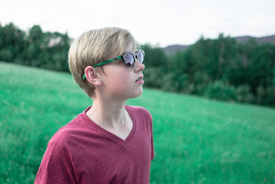 Cute boy standing on field