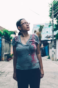 Young woman looking away in city