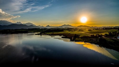 Scenic view of lake against sky during sunset