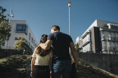 Father and daughter embracing on way home