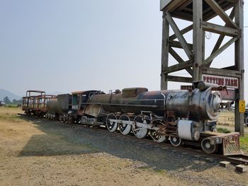 Train on railroad tracks against clear sky