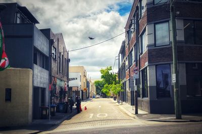 Street amidst buildings in city against sky