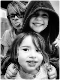 Close-up portrait of happy siblings at home