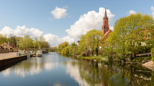 Panoramic view of trees and city against sky