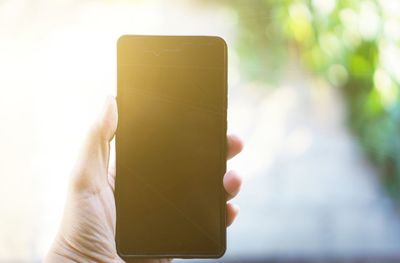 Close-up of hand holding mobile phone