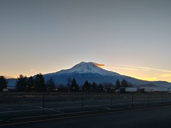 Scenic view of snowcapped mountains against sky during sunset