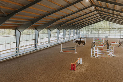 View of horse rider using indoor riding paddock