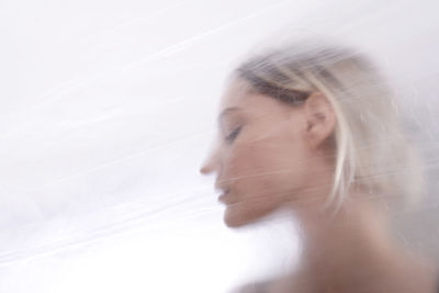 Woman against translucent glass