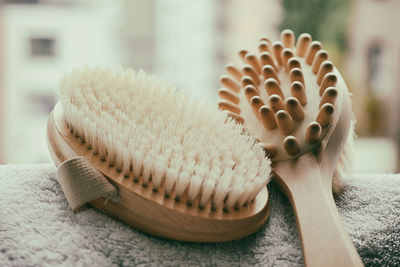 Close-up of brushes on towel against window