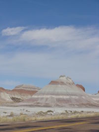 View of desert against cloudy sky