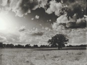 Scenic view of field against cloudy sky