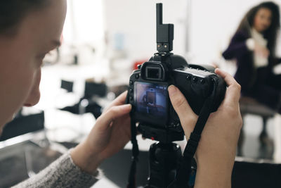 Woman photographing in studio