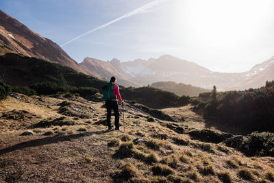 Rear view of man on mountain against sky