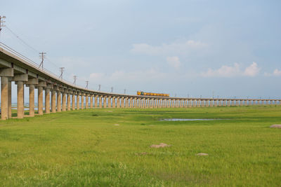 Built structure on field against sky