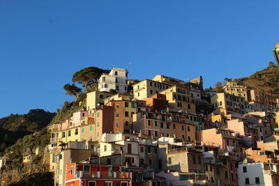 Residential buildings against clear blue sky