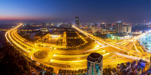 High angle view of illuminated cityscape against sky at night