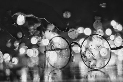 Close-up of illuminated lights on glass table