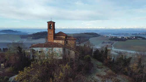 Panoramic view of a church and alps in piemont, italy 