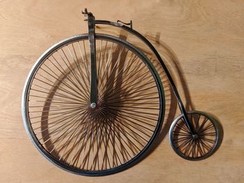 High angle view of bicycle wheel on wood