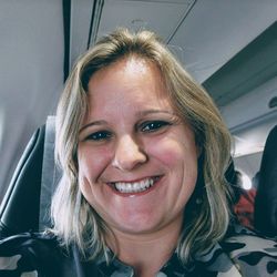 Portrait of smiling mature woman sitting on airplane seat