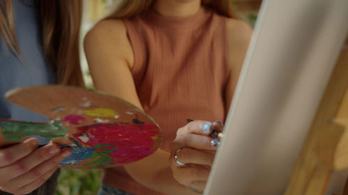 Midsection of woman using mobile phone