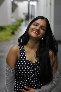 Portrait of smiling young woman standing outdoors