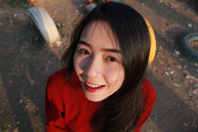 High angle portrait of smiling young woman at park