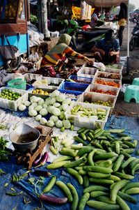 Sidoarjo-indonesia, may 2022. vegetable seller serving buyers at the booth of a traditional market