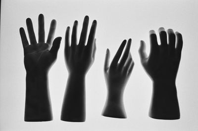 Close-up of hand touching glass over white background