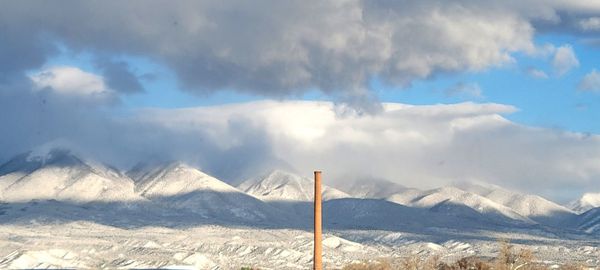 Scenic view of snowcapped mountains against sky