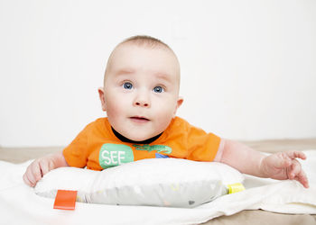 Portrait of cute baby boy on bed