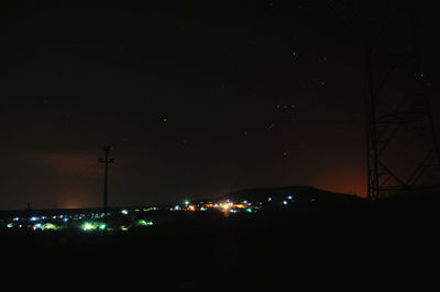 Illuminated built structure against sky at night